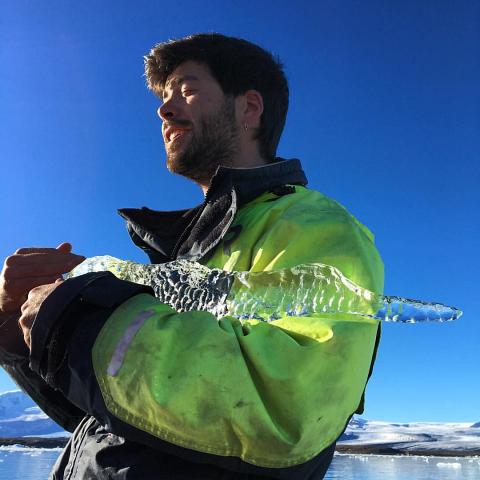Tour guide with 1000yr old chunk of ice... by Scott Joyce